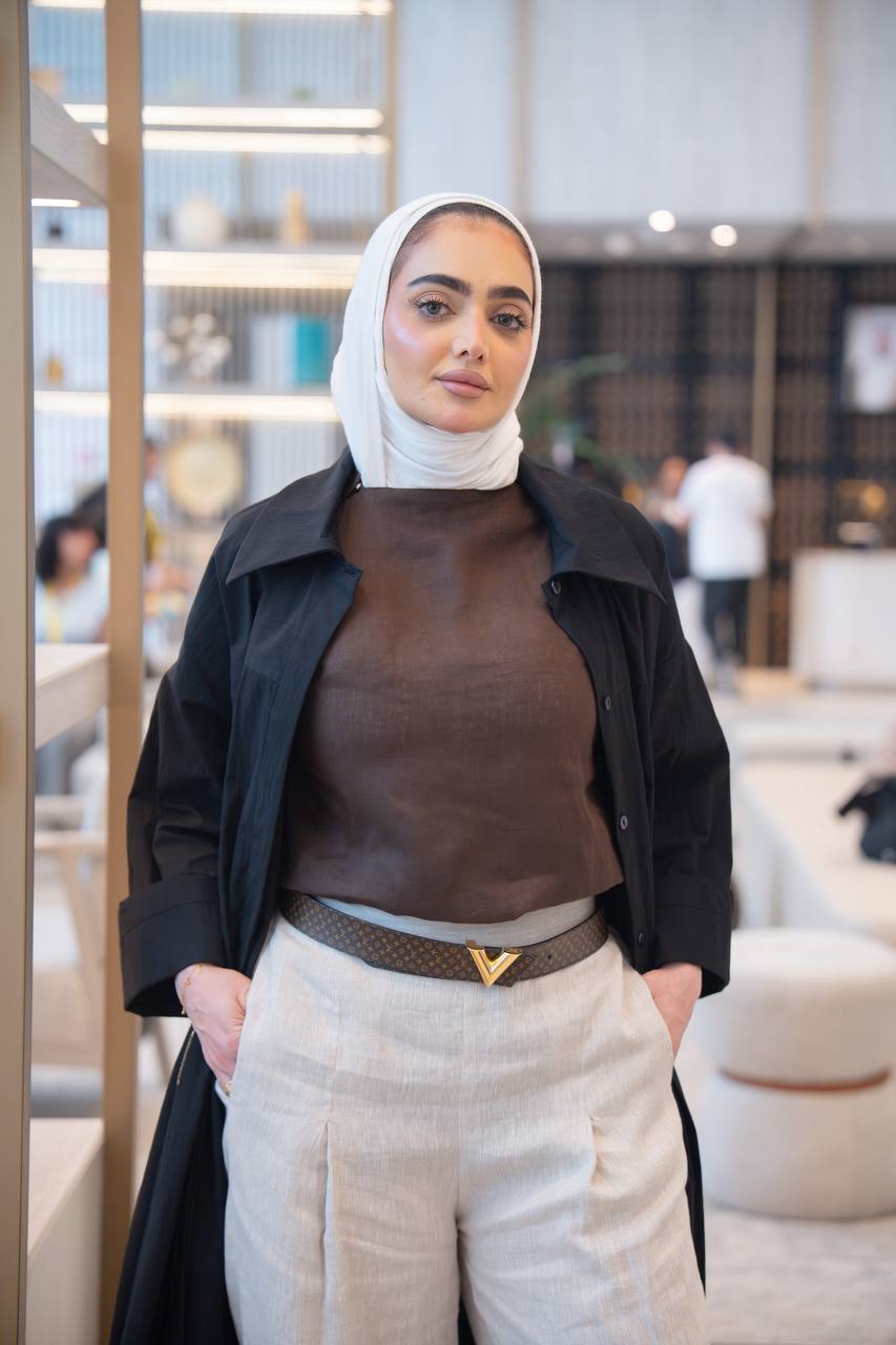 طقم ترنش كوت اسود مع بلوزة حفر و بنطلون بيج .