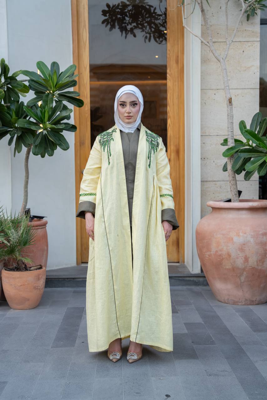 Yellow linen trench coat with hand embroidery and beading.C:1095