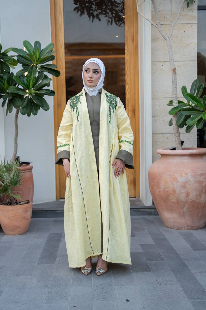 Yellow linen trench coat with hand embroidery and beading.C:1095