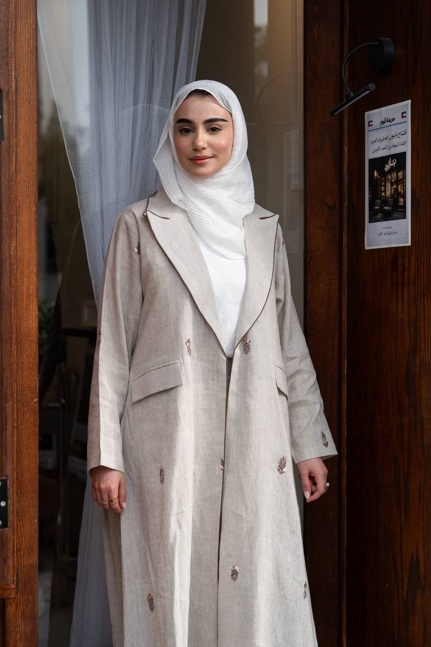Beige linen blazer with hand-stitched detailing. C:1096