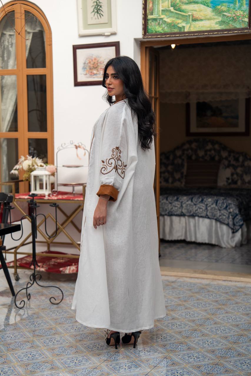White linen abaya with hand-stitched details. C:J1082