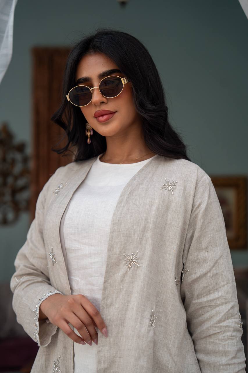 Light beige linen trench coat with hand-stitched detailing.C:J1081